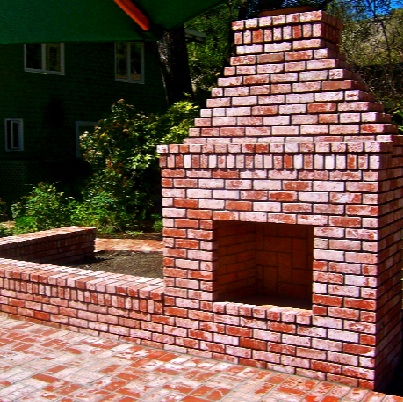 masonry brick fireplace and planter box in exterior yard landscape